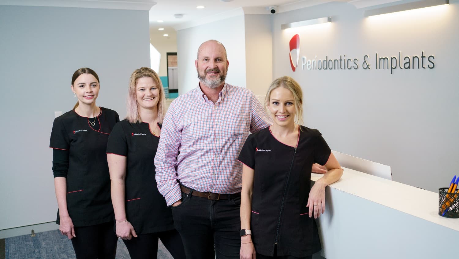 The clinic staff and the doctor are all smiling, waiting for the patients to come in. They all seem prepared and ready anytime to accommodate clients. The staff’s uniform is black, its top accented by red linings that match the clinic’s logo. The room has a well-balanced lighting that provides illumination for the entire workspace.